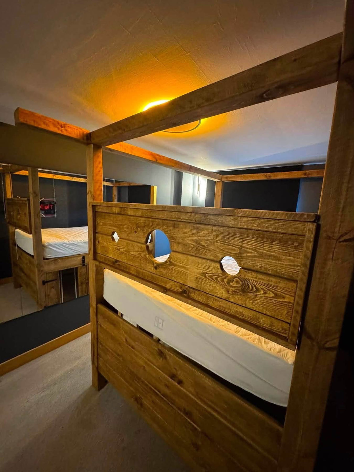 Close-up of rustic timber and stocks-style panel on the Dungeon Bed