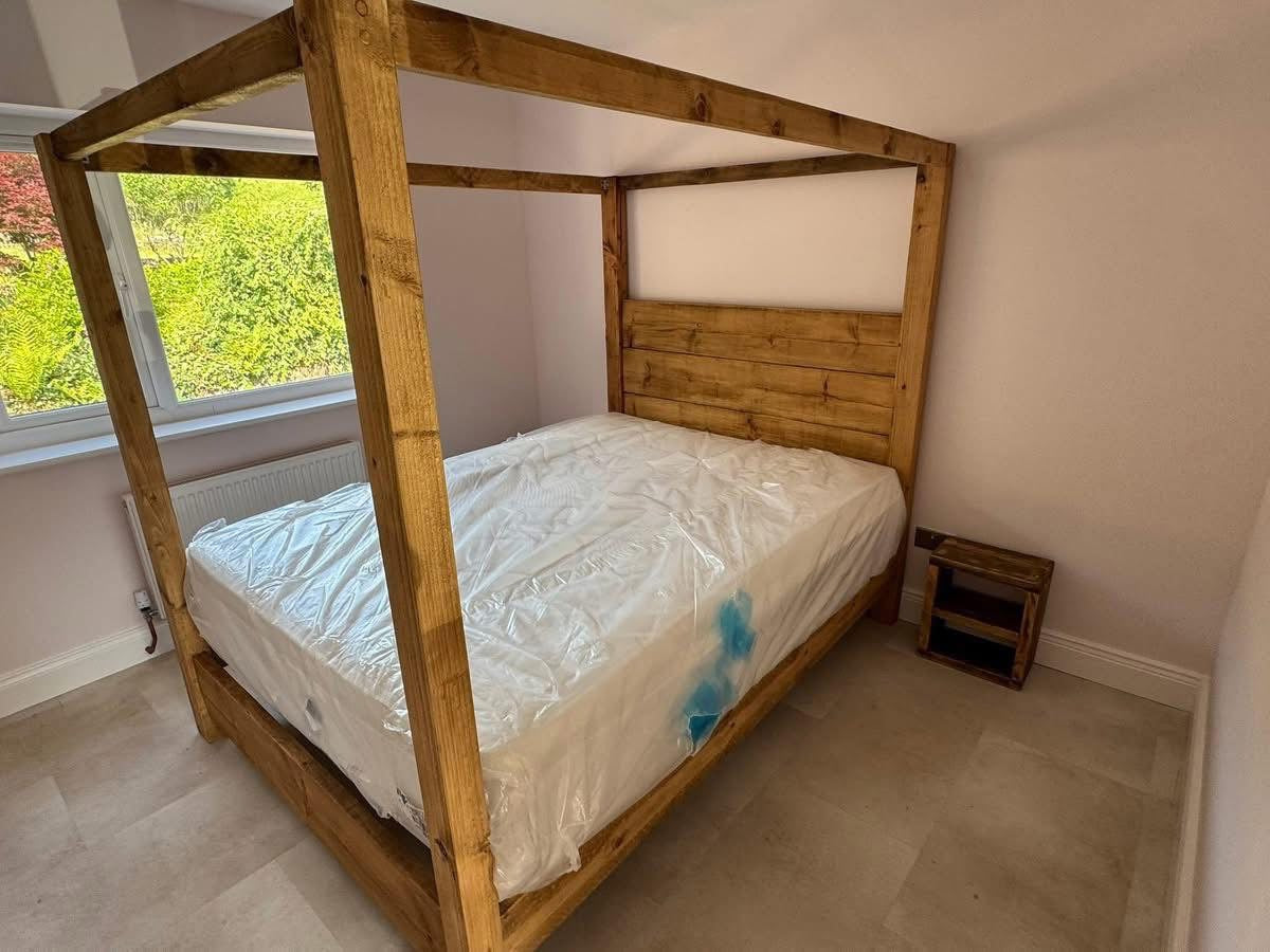 Grand wooden four poster statement bed in rustic finish
