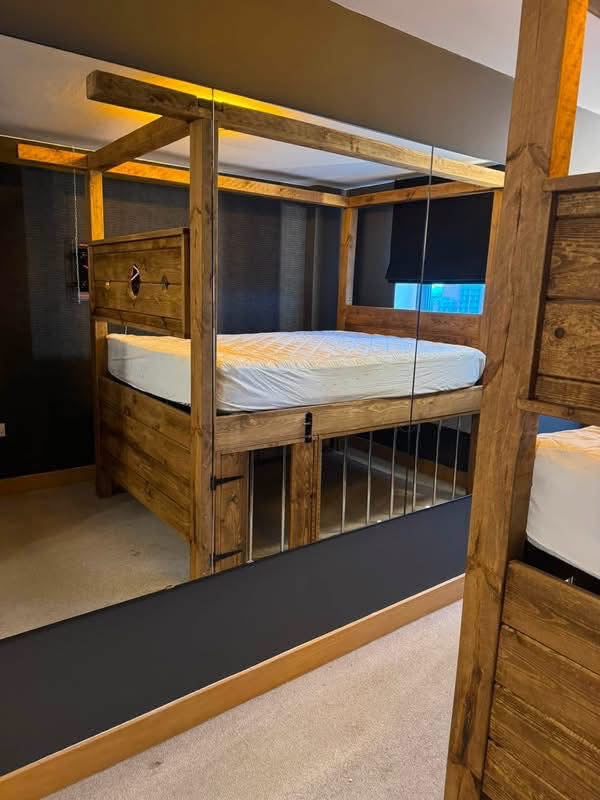 Dungeon Bed side view showing rustic timber frame and under-bed detail