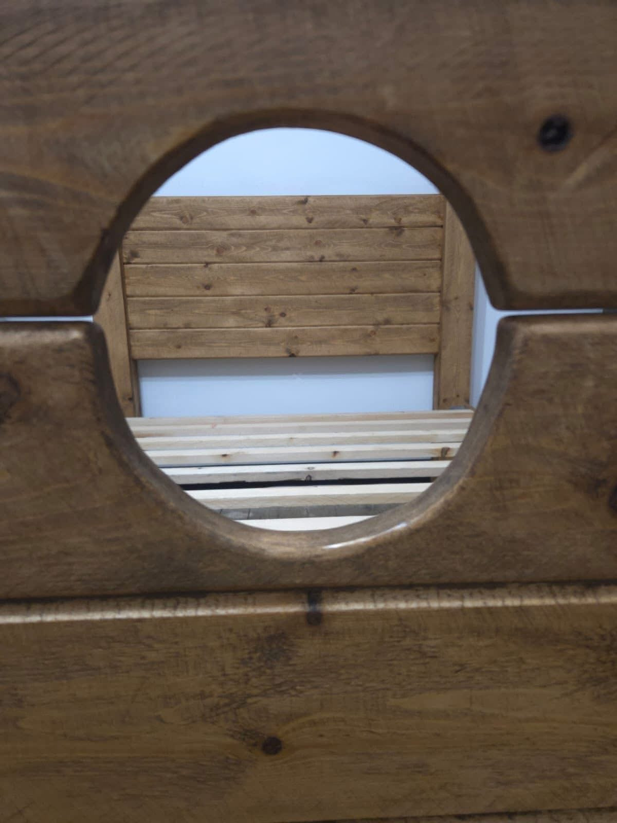 Close-up of the Jester Bed wooden stocks opening
