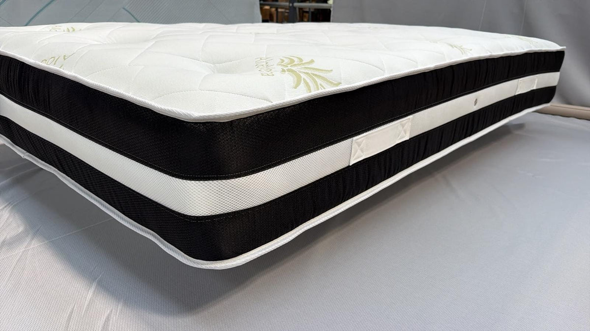Side view of the mattress showing its black and white border and handles